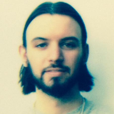 Headshot of a man who appears to be white with long dark hair and a short beard wearing a slight smile and a light-colored shirt. The background is a white wall and the image has an instagram-like filter applied.